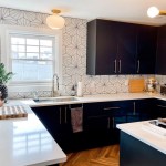 Akron kitchen remodeling project with black cabinets, gold accents, and patterned backsplash