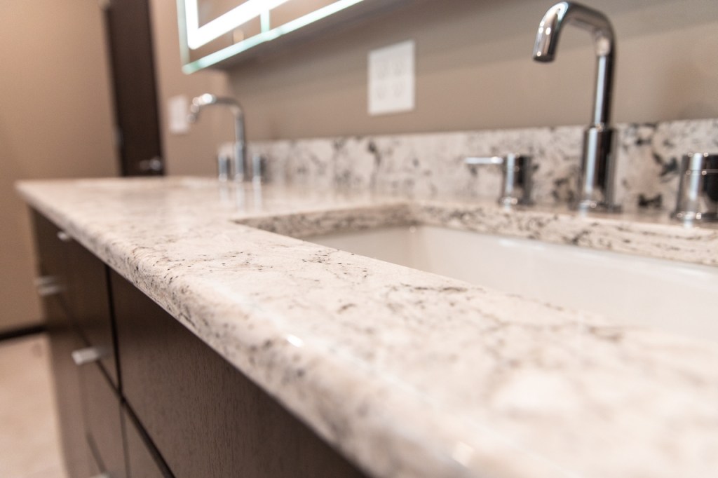 Luxury shower with glass block wall and illuminated mirror reflection