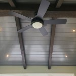 Vaulted sunroom ceiling with recessed lights and cross beams