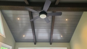 Vaulted sunroom ceiling with recessed lights and cross beams