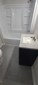 Overhead view of vanity and tub in remodeled bathroom with tile flooring