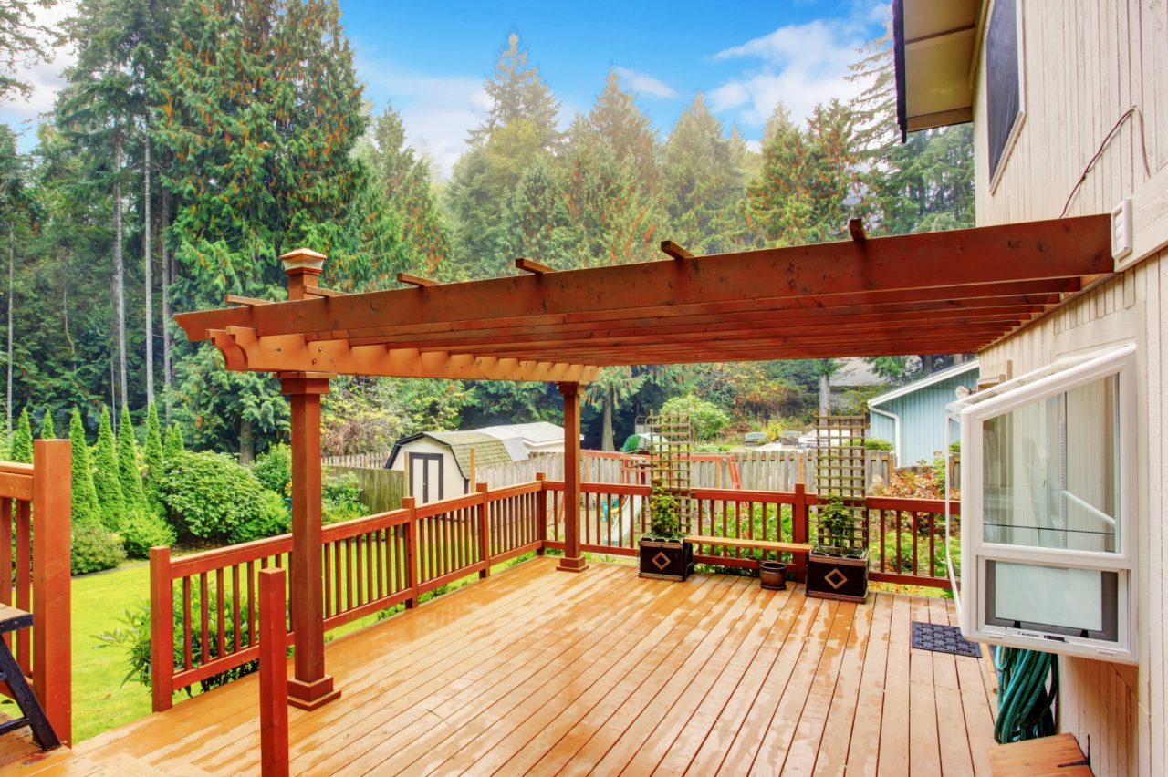 Custom wood deck and pergola home addition in Akron backyard