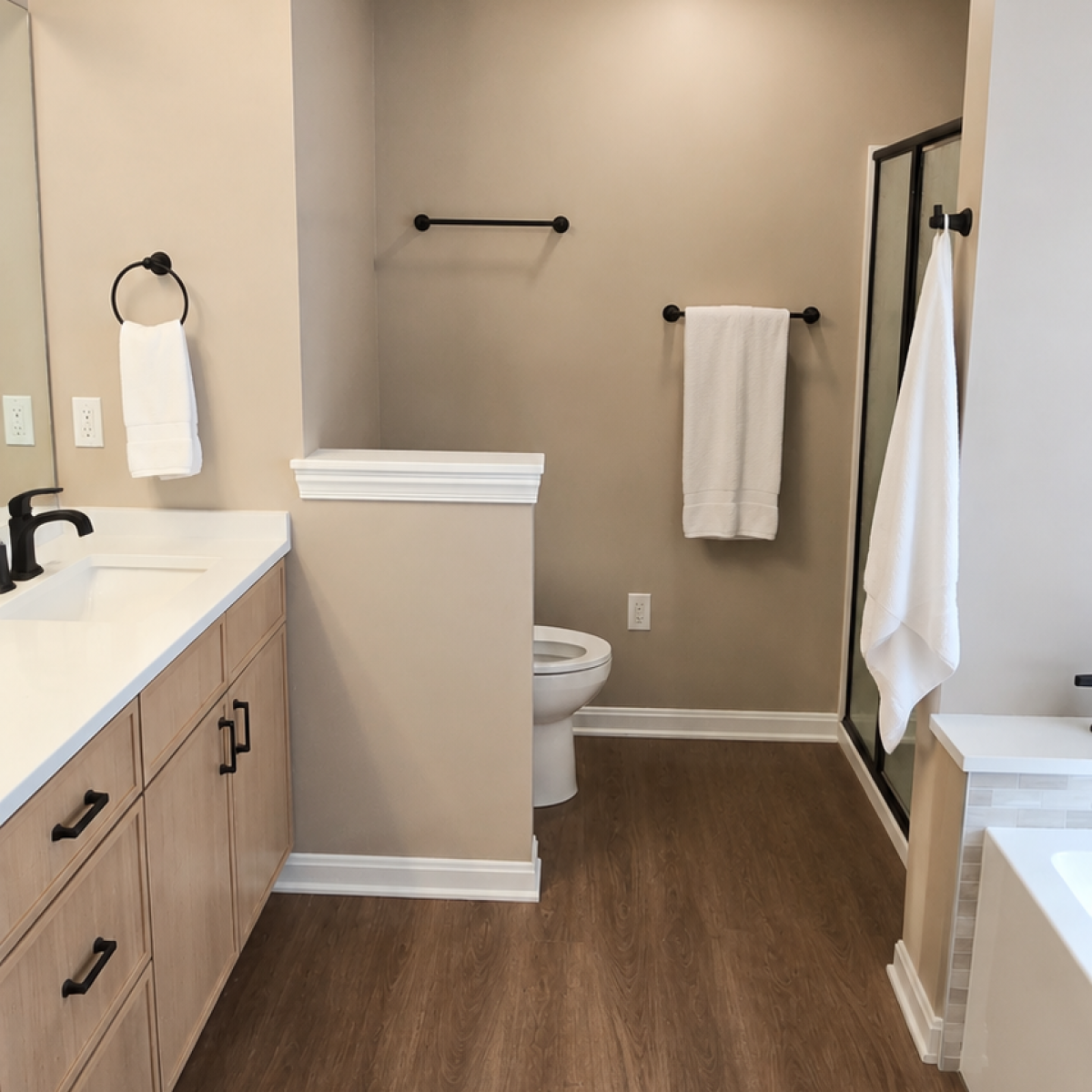 Modern bathroom renovation in Akron OH featuring walk-in shower, custom vanity, wood-look flooring, matte black fixtures, and updated bathroom design.